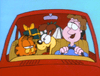 A cartoon image of a man driving a red car accompanied by an orange cat and a yellow dog. The cat looks unimpressed, while the dog appears happy. The man is smiling and has short brown hair and glasses. The background is a clear blue sky.