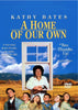 DVD cover of the movie "A Home of Our Own" featuring Kathy Bates. It shows Bates in a window frame smiling, surrounded by six children against a backdrop of a rural landscape with mountains. The text includes a movie rating and a short description of the plot.