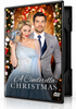 A woman in a formal gown holding a masquerade mask and a man in a suit stand together in front of a Christmas wreath on the cover of A Cinderella Christmas (2016) DVD.