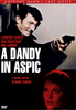 Movie poster for A Dandy in Aspic (1968) DVD featuring a man smiling and pointing a gun, with a woman’s face beneath him. The text promotes it as Anthony Mann’s final film and stars Laurence Harvey, Tom Courtenay, and Mia Farrow. An essential addition for collectors of rare and classic movies on DVD.