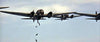A formation of bomber planes releases bombs mid-air against a blue sky—capturing the thrilling aerial combat featured in the "Battle of Britain (1969)" DVD.