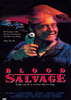 A grinning man in work clothes and a welding mask stands holding a green flashlight, with wrecked cars behind him. The text reads: BLOOD SALVAGE. If Jake can’t fix it, it’s been dead too long. The Blood Salvage DVD (1990) is a rare horror film that crafts a dark, eerie atmosphere with chilling undertones of organ harvesting—an ideal addition to any horror DVD collection.