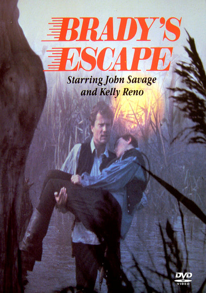 A man carries another man through tall grass at night in this classic Hungarian cowboy film. The text reads: Brady’s Escape DVD (1984) Starring John Savage and Kelly Reno. A DVD video logo is in the lower right corner, emphasizing its status as a rare movie available on DVD.
