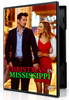 A man in a suit and a woman in a red dress hold hands while walking together on the cover of the Christmas in Mississippi (2017) DVD.