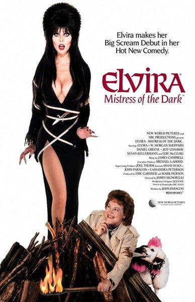 Elvira, in a black dress, stands by a bonfire with a woman, a white dog, and the title Elvira: Mistress of the Dark. Text above reads: Elvira makes her Big Scream Debut in her Hot New Comedy—a cult classic comedy now available as Elvira: Mistress of the Dark (1988) DVD for fans and collectors alike.