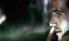 A close-up of a man's sweaty face, tense and intense in dim light, evokes the suspense of a gripping scene from the We Go On (2016) DVD. A blurry background adds to the dramatic effect.