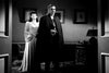 A man in a black cape stands in a dimly lit room, evoking classic horror. The scene recalls the chilling atmosphere of "Son of Dracula (1943)" on DVD.