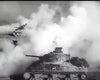 A black-and-white image from the They Were Not Divided (1950) DVD shows two military tanks advancing through thick battlefield smoke, with one tank prominent in the foreground and the other partly obscured by haze.
