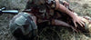 A soldier in camouflage lies injured on dry grass, rifle nearby—reminiscent of scenes from rare DVDs like Tornado: The Last Blood (1983) DVD.