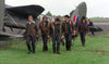 Six men in vintage flight gear walk beside WWII planes on green fields under overcast skies, capturing the classic wartime atmosphere of vintage movies. Featured: Mosquito Squadron (1969) DVD.