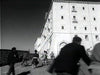 A dynamic black-and-white image shows people running uphill toward a stone building, evoking the urgent atmosphere found in rare films like "The Green Devils of Monte Cassino (1958) DVD.