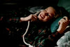 A person smiles on a bed talking on the phone, evoking the cozy nostalgia of vintage classics, as seen in "When Friendship Kills (1996)" DVD.