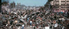 A devastated urban area of rubble and collapsed buildings, with a few people walking among ruins under a clear sky, captures scenes reminiscent of those in Godzilla Minus One (2023) DVD.