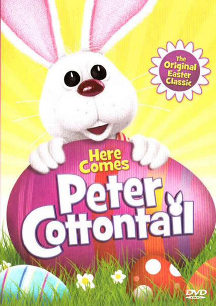 The DVD cover for Here Comes Peter Cottontail DVD (1971) features a cartoon bunny holding a pink egg-shaped sign that says “Here Comes Peter Cottontail.” The bright yellow background is decorated with Easter eggs and grass along the bottom, and a text balloon proclaims “The Original Easter Classic.” This delightful DVD includes the beloved 1971 stop-motion TV special that has become an iconic Easter Bunny movie for families everywhere.