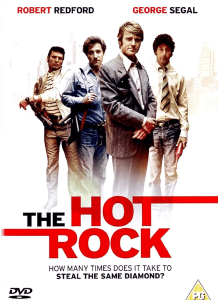 Four men dressed in 1970s style pose confidently before a faded city backdrop; the title "The Hot Rock" stands out in bold red and black letters. Starring Robert Redford, The Hot Rock (1972) DVD delivers a classic heist adventure filled with twists and surprises. Featuring the tagline: "How many times does it take to steal the same diamond?"—this collector’s edition brings all the stylish caper fun right to your home.