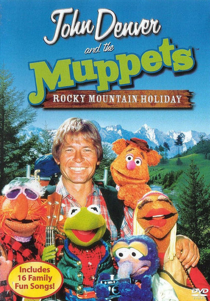John Denver is pictured smiling outdoors alongside Muppets characters, with mountains providing a scenic backdrop. The DVD cover features the title Rocky Mountain Holiday with John Denver and the Muppets (1983) DVD, making this a delightful find for anyone looking to add a rare movie to their DVD collection.