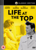 DVD cover for Life At The Top DVD (1965), a classic British drama film featuring Laurence Harvey. In the foreground, a man in a trench coat stands confidently, while a yellow-toned image of a woman appears in the background. The title and cast names—including the notable performance by Laurence Harvey—are displayed above in bold black and white text, making this Life At The Top DVD (1965) an essential addition to any collection.