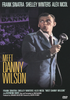 A man in a suit sings into a microphone on stage, with text above reading Frank Sinatra, Shelley Winters, and Alex Nicol. The large yellow title displays Meet Danny Wilson. A “We Love Danny” sign appears in the background, highlighting this scene from the classic film Meet Danny Wilson DVD (1951), starring Frank Sinatra and now available on DVD.
