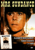 A woman with a serious expression gazes out a window on the cover of the Mrs. Sundance DVD (1974). The artwork displays a wanted poster and lists actors Elizabeth Montgomery, Robert Foxworth, and L.Q. Jones—a rare classic film that adds fresh intrigue for fans of the Sundance Kid DVD collection.