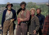 Four people in western attire stand outdoors among trees and hills, their serious faces evoking a tense scene from The Naked Spur (1953) DVD, reminiscent of classic James Stewart westerns.