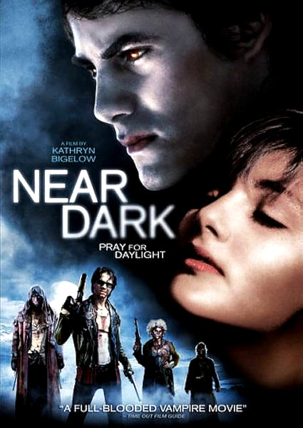 DVD cover art for Near Dark (1987) featuring a close-up of a man with glowing eyes looking over a woman, with four figures in a desert landscape below and the title Near Dark in the center.