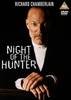 A serious, bald man in a suit stares forward with hands folded, accompanied by the text NIGHT OF THE HUNTER, Richard Chamberlain, and a PG DVD logo on a dark background—making the Night of the Hunter DVD (1991) an essential addition for collectors and fans of classic movies on DVD.