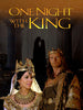 A man and a woman dressed in regal costumes and crowns stand before grand columns, capturing the opulent atmosphere of a biblical epic on the cover of One Night with the King (2006) DVD. Above them, the film’s title appears, while silhouettes embracing in the background suggest themes of romance and intrigue at the heart of this historical drama.