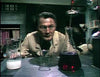 Jack Palance, dressed in a lab coat, looks intently over a laboratory table with colorful glass beakers in a scene from The Strange Case of Dr. Jekyll and Mr. Hyde (1968) DVD, reminiscent of a classic gothic horror film.