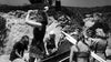 On the cover of the "Saga of the Viking Women (1957) DVD," women in rugged attire work on a rocky shore—one wields a sledgehammer in front, while others handle wooden beams and tools beside her, highlighting this adventurous Viking tale.