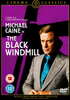 DVD cover for The Black Windmill DVD (1974) featuring Michael Caine in a blue suit, posed before a striking black windmill silhouette on a purple background. Prominent text displays the film’s title and age rating—an essential addition for any classic movie enthusiast or collector seeking rare movies on DVD, such as this unforgettable Michael Caine film.