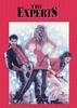 Three people stand in front of a blue starry background. A woman in a red dress, holding a gun, faces away from the camera while two men—one of them being John Travolta—look at her from either side. At the top, text reads "The Experts," calling attention to this classic 1989 comedy now available on The Experts DVD (1989).
