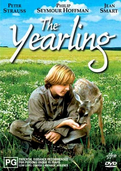 A young boy dressed in gray sits in a field feeding a fawn. Above them is the movie title, The Yearling, with actor names listed at the top. In the lower corners are a PG rating icon and DVD symbol, highlighting this classic family film—now available as The Yearling (1994) DVD.