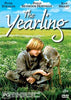 A young boy dressed in gray sits in a field feeding a fawn. Above them is the movie title, The Yearling, with actor names listed at the top. In the lower corners are a PG rating icon and DVD symbol, highlighting this classic family film—now available as The Yearling (1994) DVD.