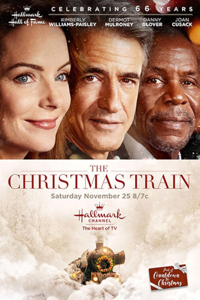 Three smiling people appear above the title The Christmas Train (2017) DVD, starring Dermot Mulroney. Snow falls around a festive train, with actors' names and movie details featured for the ultimate holiday movie event.