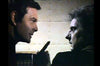 A man on the left gestures intently to a tense man on the right; both appear in dramatic side profile and dim lighting, evoking scenes from classic movies like the "Count Dracula (1977) DVD.