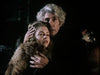 An older man with gray hair protectively holds a young woman in a fur coat, both looking concerned off-camera—capturing the suspenseful gothic atmosphere of the "Count Dracula (1977) DVD.