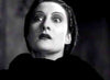 A black and white close-up of a woman with wide eyes and dark lipstick gazes upward with a dramatic, intense expression—evoking the timeless allure of classic horror, as seen on the cover art for Dracula’s Daughter (1939) DVD.