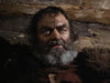 A rugged, gray-bearded man stares intensely against a wooden log backdrop, evoking Native American frontier adventures reminiscent of classic films—now available on DVD as Grayeagle (1977).