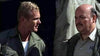 Two men in military-style jackets—one blond, the other bald with a mustache—stand talking, evoking WWII action drama. Scene from "Legion of No Return (1969)" DVD.