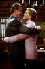 A man and woman smile warmly at each other while embracing indoors, surrounded by soft lighting and rustic wooden decor, capturing the timeless romance featured in *One Special Night* (1999) on DVD—a beautiful moment reminiscent of classic films.