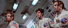 Three astronauts in white suits with mission patches and headsets sit intently in a spacecraft control room, surrounded by panels filled with buttons, switches, and flashing lights—a scene filled with suspense reminiscent of the classic disaster depicted in Meteor (1979) DVD, starring icons Sean Connery and Natalie Wood.