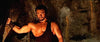A muscular man in a gladiator outfit grips a torch in a dark cave—echoing Italian peplum cinema—in Goliath and the Dragon (1960) DVD, his flexed arm and intense expression highlighted by dramatic shadows.