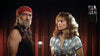 A man with a red bandana and braided hair—evoking Willie Nelson—stands next to a woman with curly hair, both gazing forward. Indoors, a microphone is visible, hinting at a recording or performance scene likely related to the Songwriter (1984) DVD.