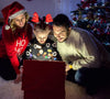 A family gathers by the Christmas tree, beaming as a child in antlers unwraps a glowing gift box, capturing the cozy, festive spirit and heartwarming glow of “Magic Stocking (2015)” on DVD—a scene that feels straight out of this beloved holiday film.