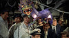 A group of sailors in uniform gathers around a colorful dragon puppet, evoking scenes from classic naval movies like the "Pursuit of Graf Spee (1956)" DVD, with ropes and beams reminiscent of a World War II setting.