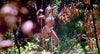 A woman in a nature-inspired costume poses in a sunlit jungle, evoking the magic of 80s fantasy adventure—just like 'Sinbad of the 7 Seas (1989)' DVD.