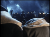 In the foreground, people bow their heads as men in hats and vintage cars evoke classic mafia vibes, silhouetted against a blue-lit, smoky night—capturing the dramatic tension of the Killer Instinct DVD (1992).