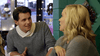 A man and a woman sit indoors at a decorated table, talking amid festive lights and wreaths that evoke the cozy, vintage atmosphere of classic movies like Hearts of Christmas (2016) DVD.