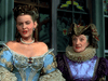 Two women in elaborate, colorful period costumes stand side by side before stained glass windows, adorned with pearls and ornate headpieces—evoking a scene from the rare The Adventures of Don Juan (1948) DVD.
