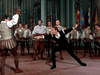 A group of men in period costumes watch an intense fencing duel, with medieval banners in the background—a rare scene from "The Adventures of Don Juan (1948) DVD," reminiscent of classic Errol Flynn swashbuckling films.